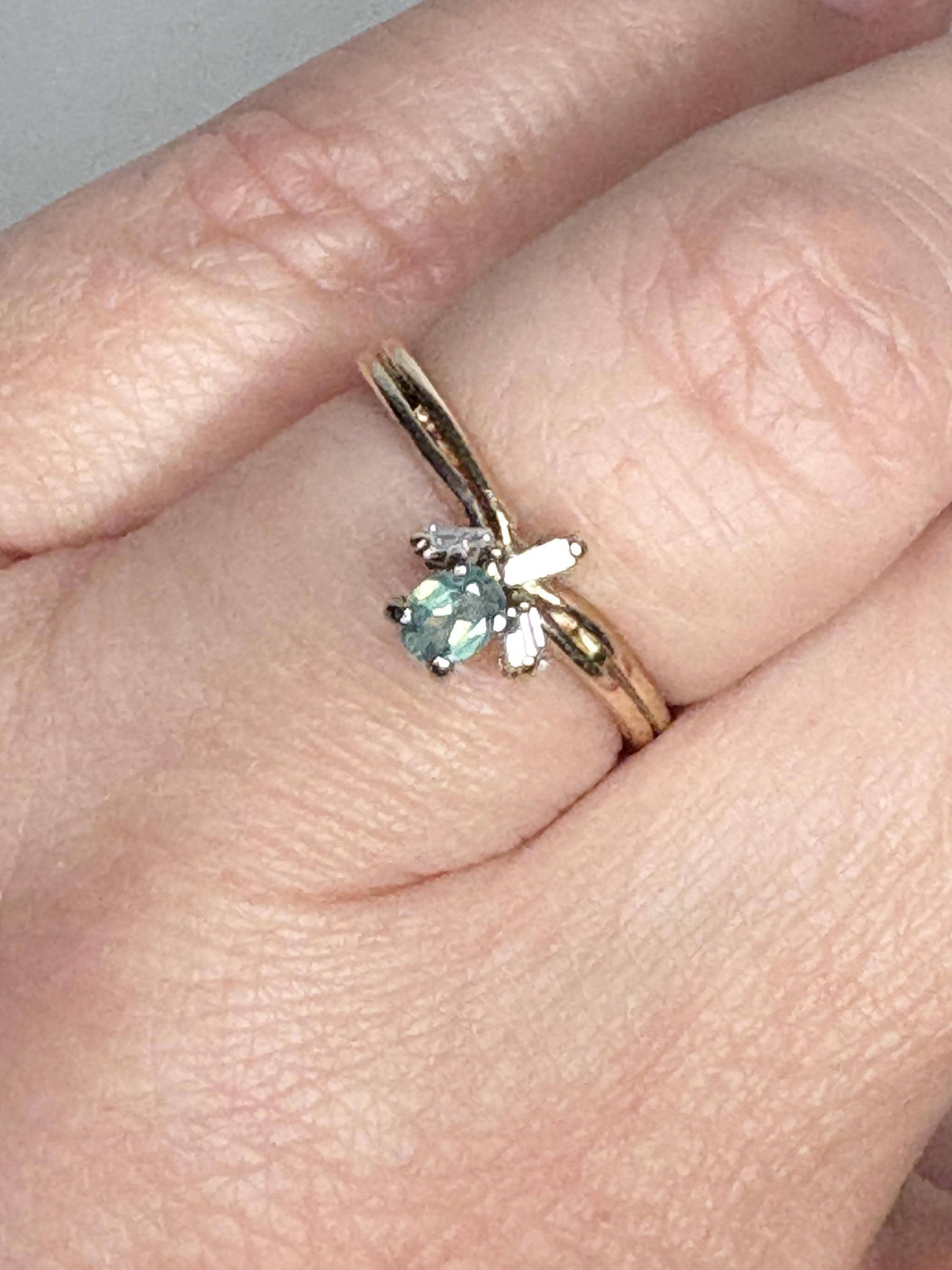 14k gold ring with an oval alexandrite and baguette diamonds.