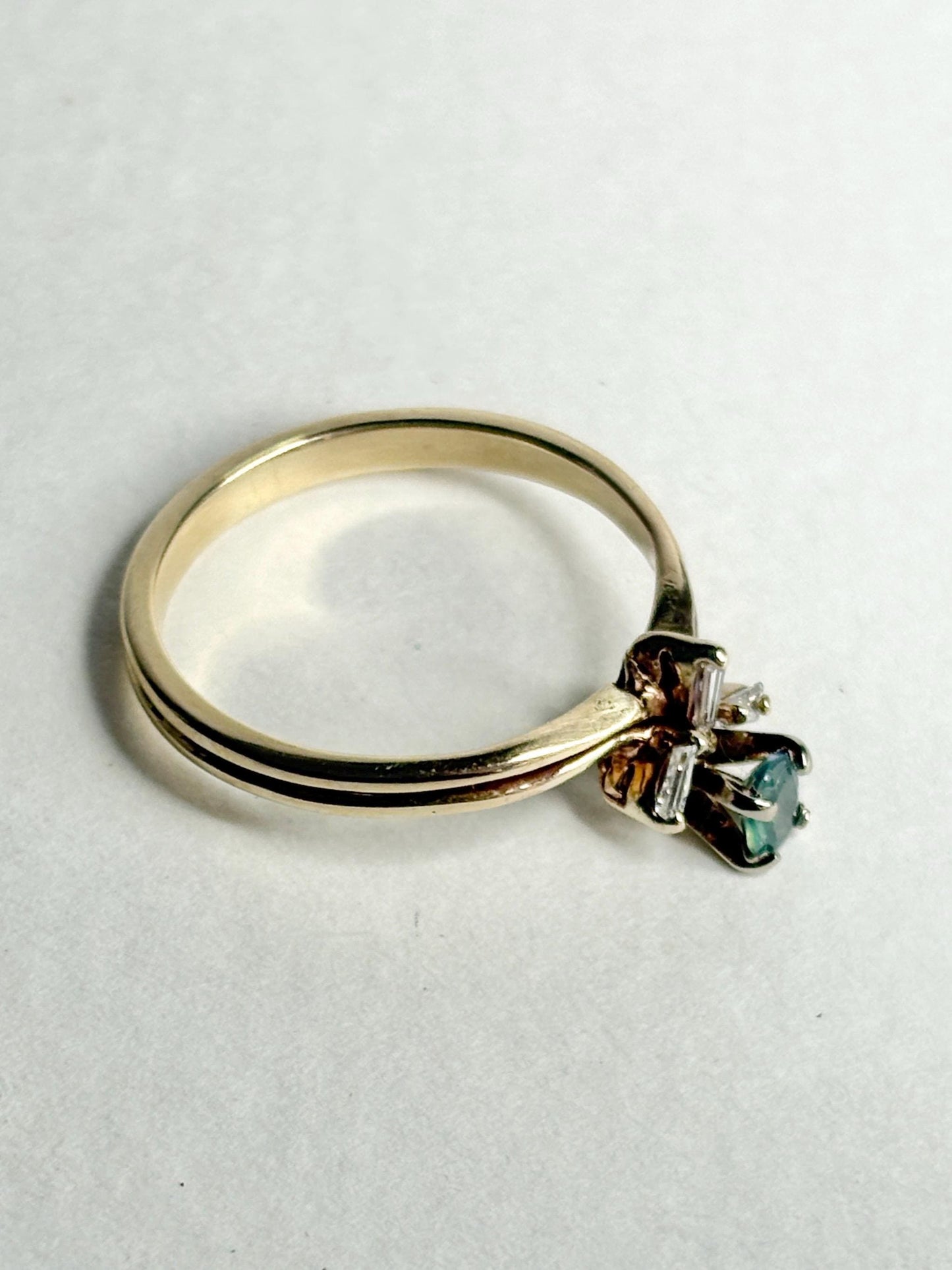 14k gold ring with a pear-shaped alexandrite and baguette diamonds.