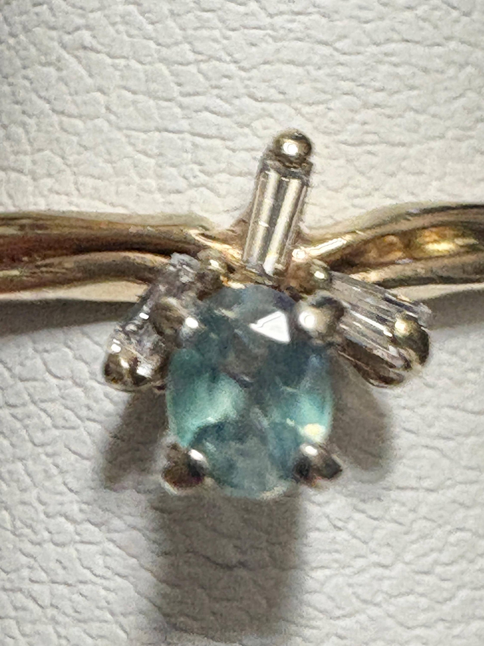 Ring with oval alexandrite and baguette diamonds in 14k gold.