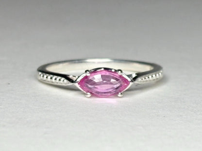 Sterling silver ring with a pink marquise sapphire set east-west.