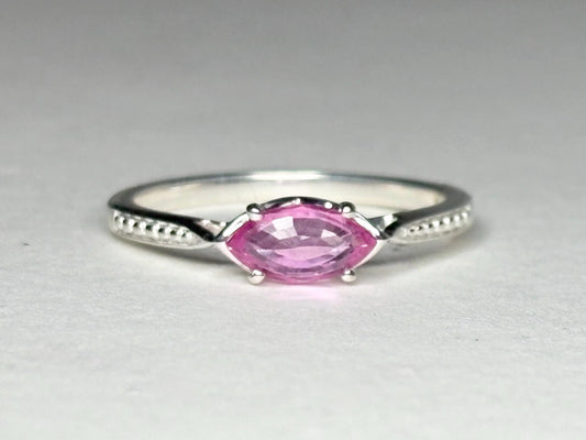 Sterling silver ring with a pink marquise sapphire set east-west.