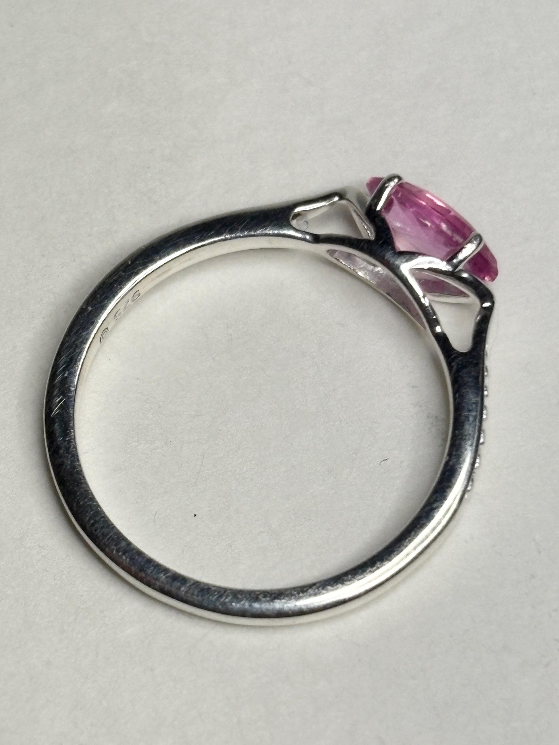 Sterling silver ring with a pink marquise sapphire set east west.