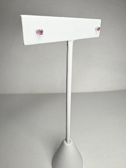 Solid 14k white gold stud earrings with round rhodolite garnets.