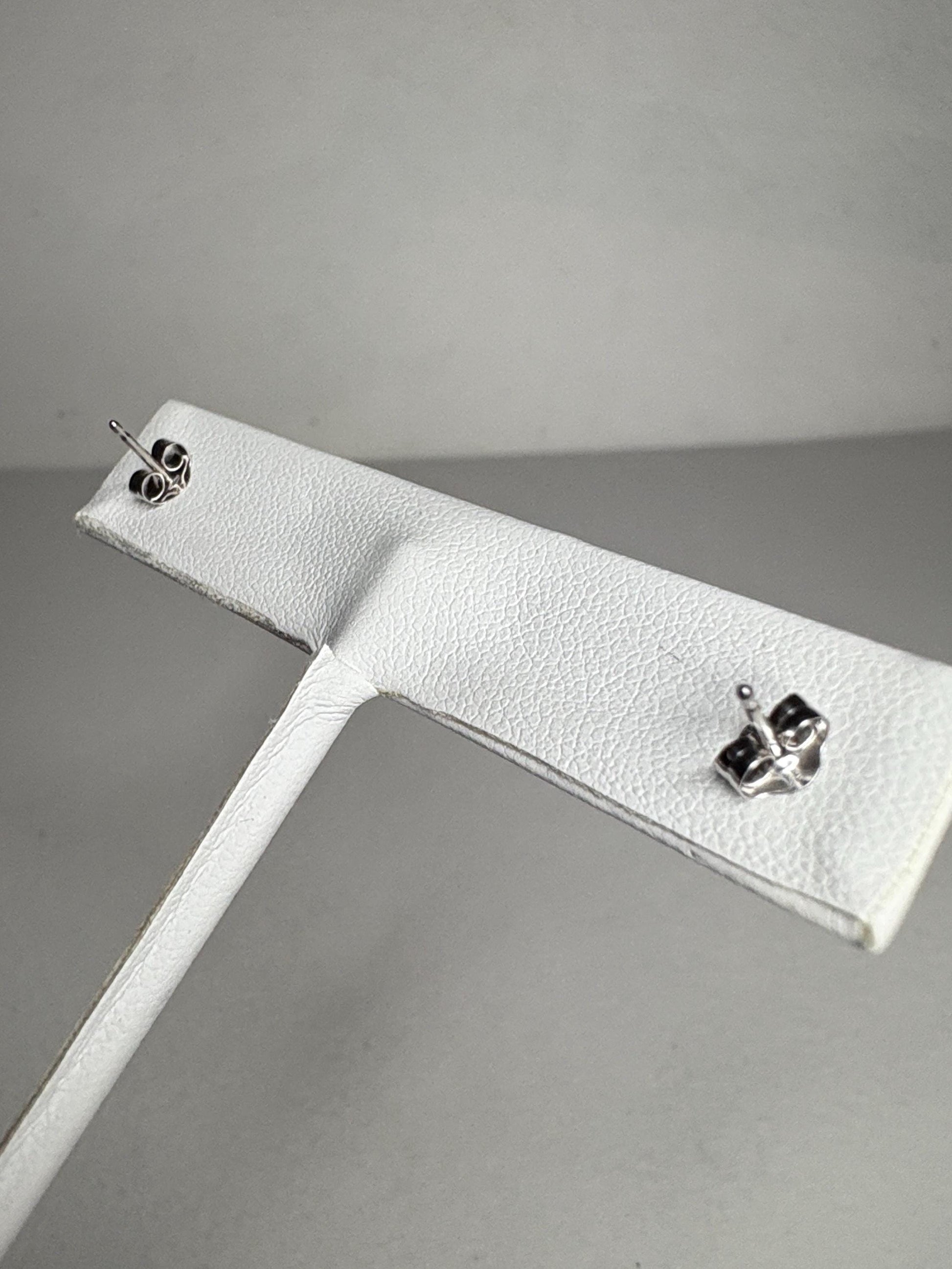 Rhodolite garnet stud earrings in 14k white gold.