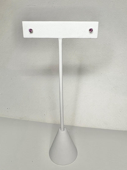 Two small, round rhodolite garnet stud earrings set in 14k white gold.