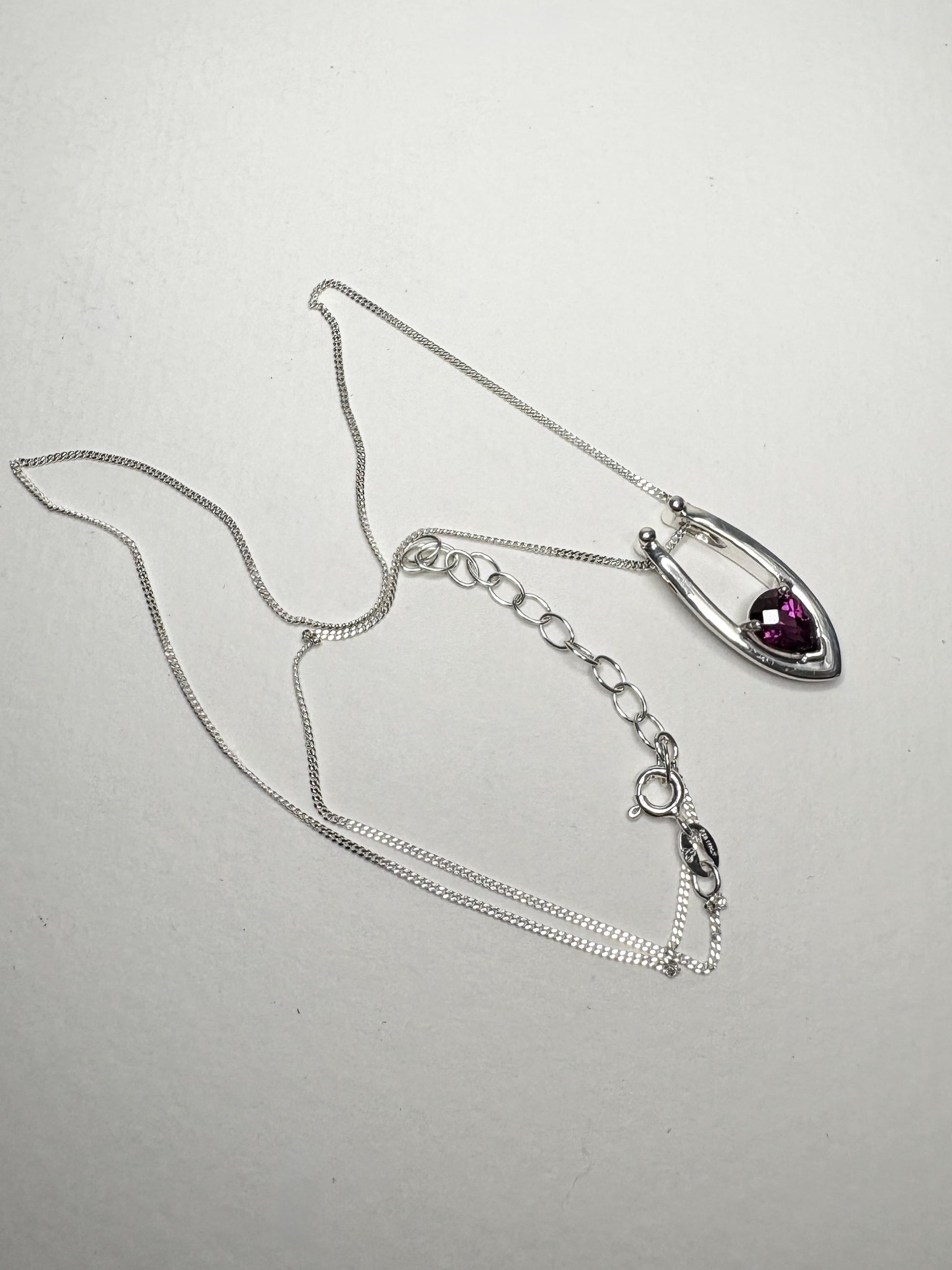 Sterling silver pendant necklace with a pear-shaped rhodolite garnet.