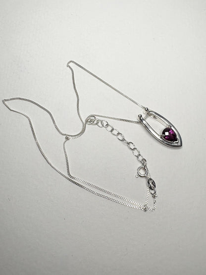 Sterling silver pendant necklace with a pear-shaped rhodolite garnet.