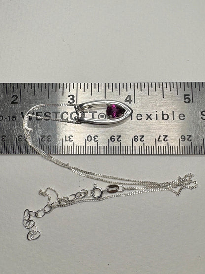 Sterling silver pendant necklace with a pear-shaped rhodolite garnet on an adjustable chain.