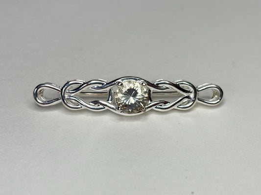 Sterling silver brooch with a yellow Oregon sunstone and Celtic knot design.