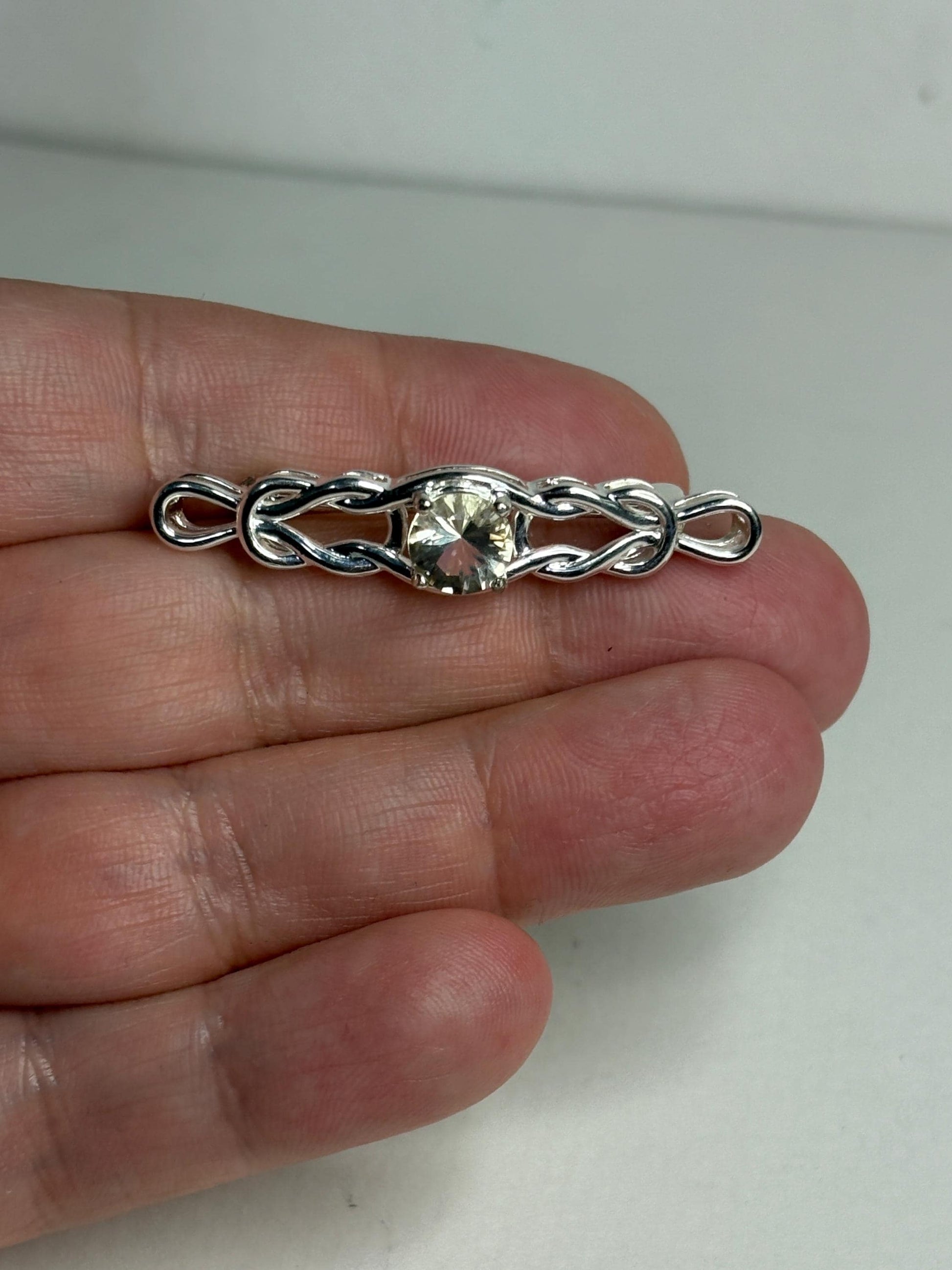 Yellow Oregon sunstone bar brooch with Celtic knot design in sterling silver.