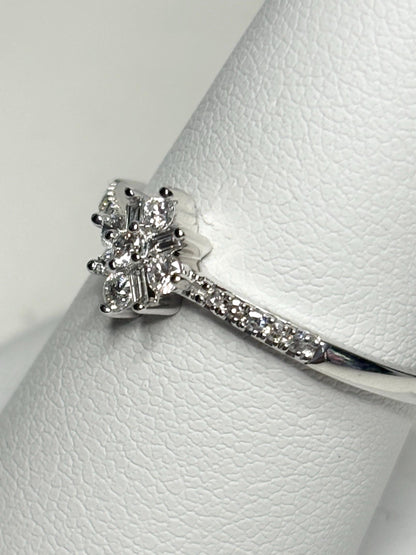 10k white gold ring with a starburst design of baguette and round diamonds.