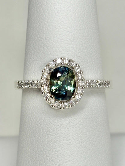 Oval bi-color sapphire and diamond halo ring in 10k white gold.