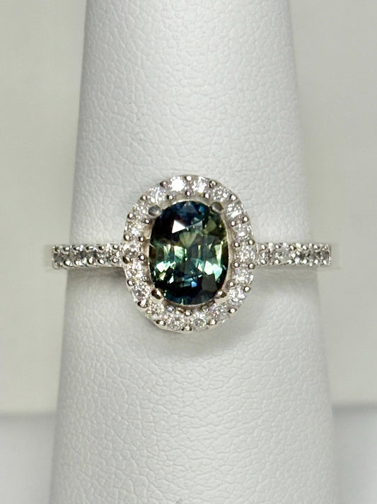 Oval bi-color sapphire and diamond halo ring in 10k white gold.