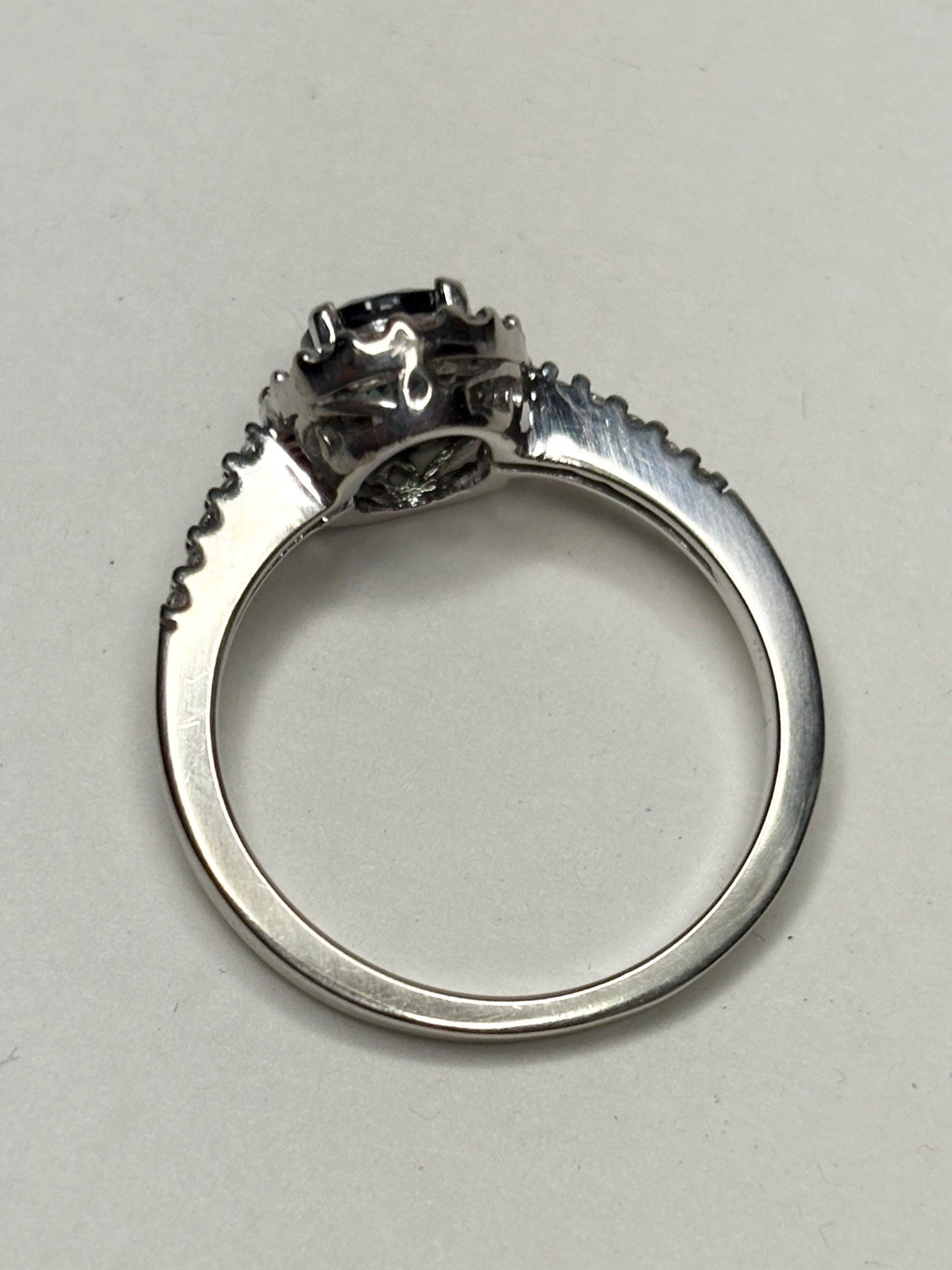 A bi-color sapphire and diamond halo ring in 10k white gold.