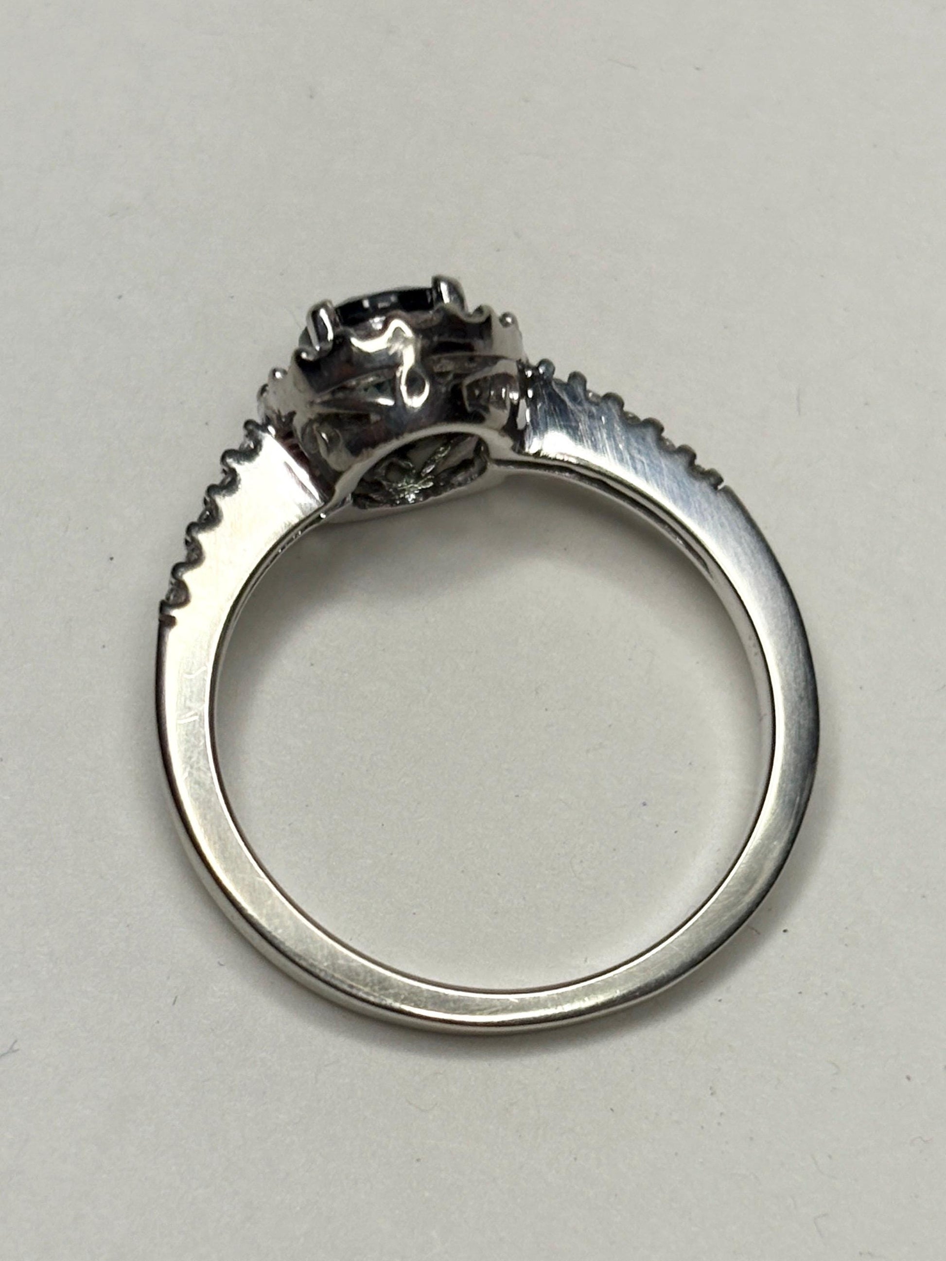 A bi-color sapphire and diamond halo ring in 10k white gold.