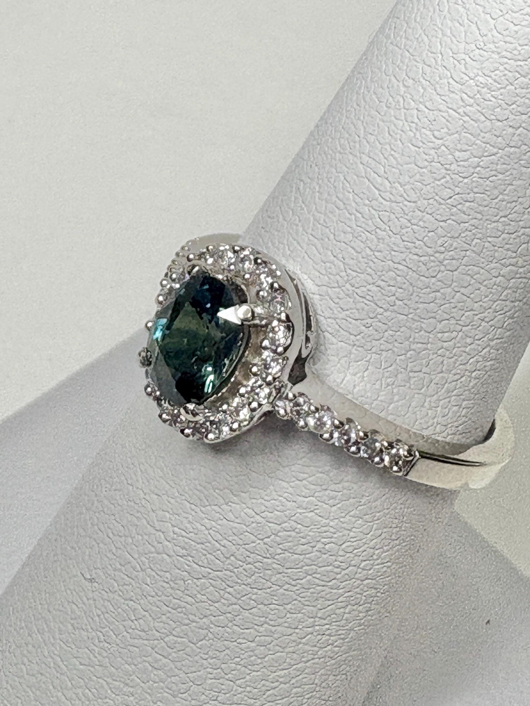 A bi-color sapphire and diamond halo ring in 10k white gold.