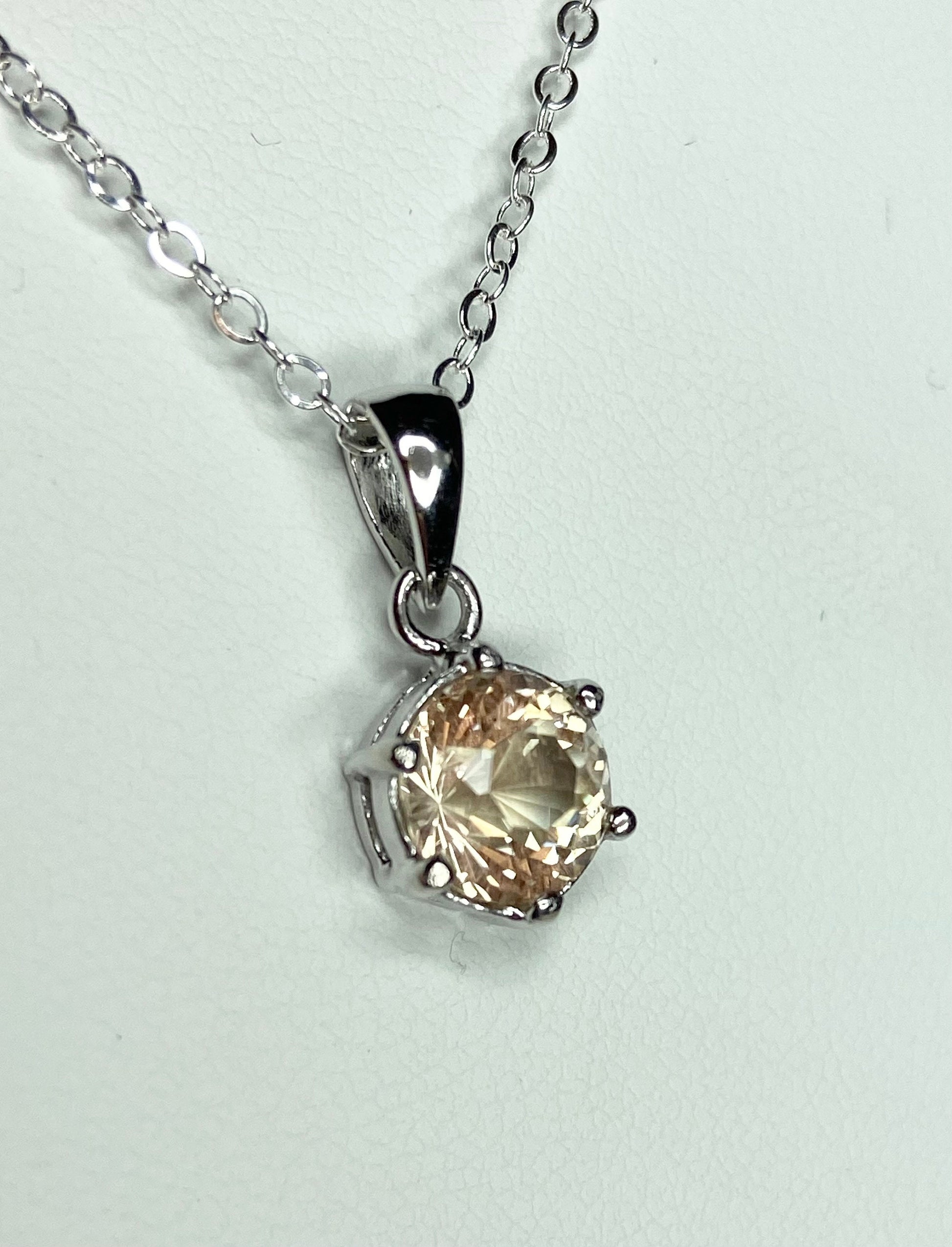 Oregon Sunstone pendant necklace with a round, 7mm, 1.51ct sunstone in a sterling silver setting.