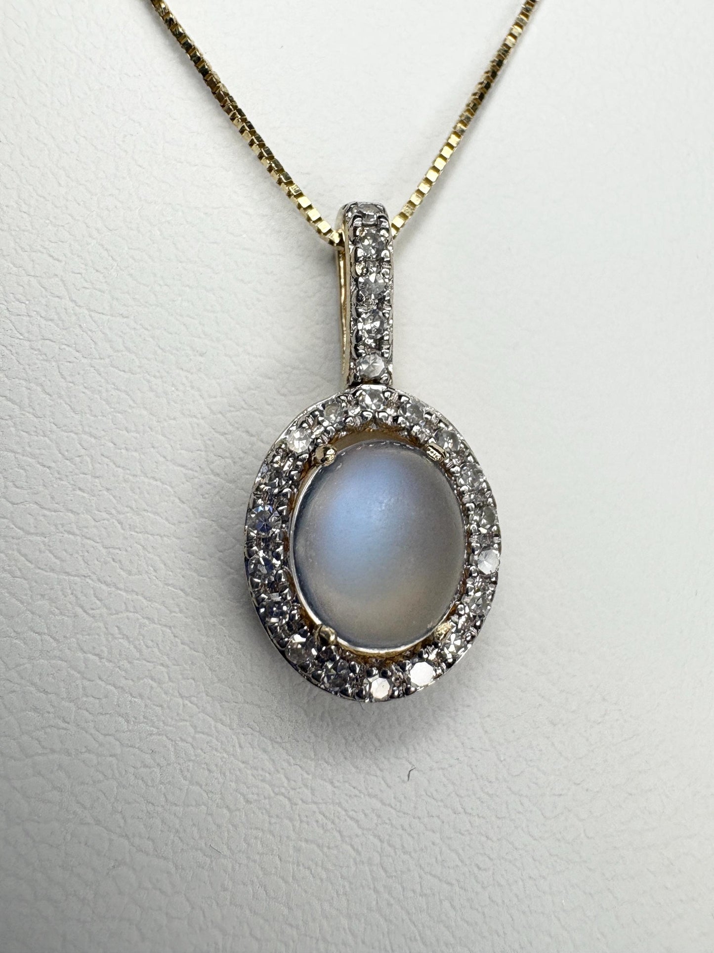 Antique blue sheen moonstone pendant necklace with diamond halo in 10k gold.