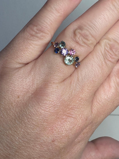 A 10k gold ring with multiple round natural sapphires in various colors.