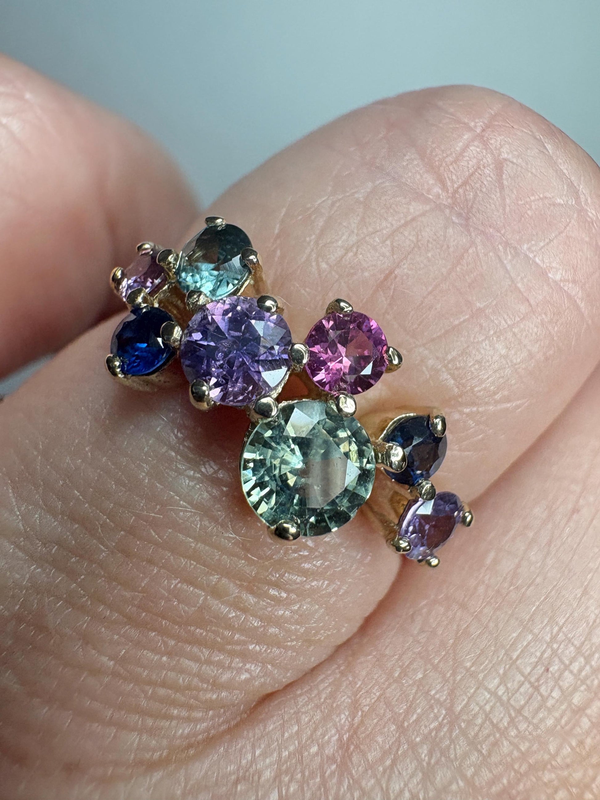 A 10k gold ring with multiple round natural sapphires in various colors.