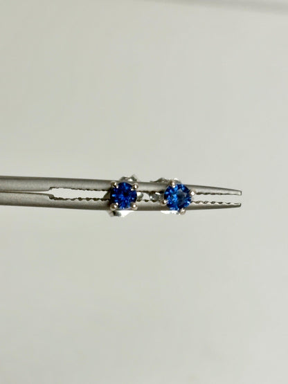 Natural dark blue sapphire stud earrings in solid 14k white gold.
