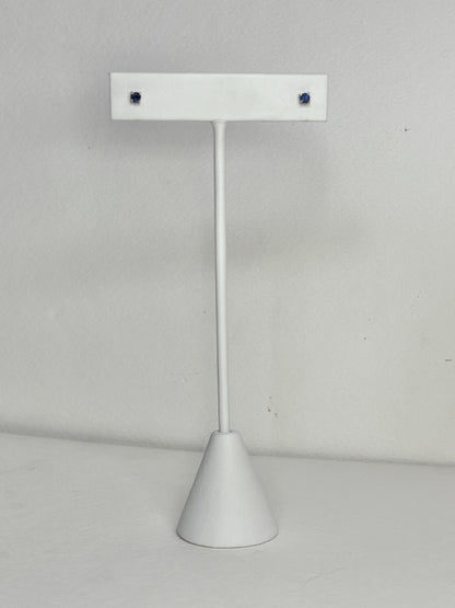 Solid 14k white gold stud earrings with small, dark blue sapphires.