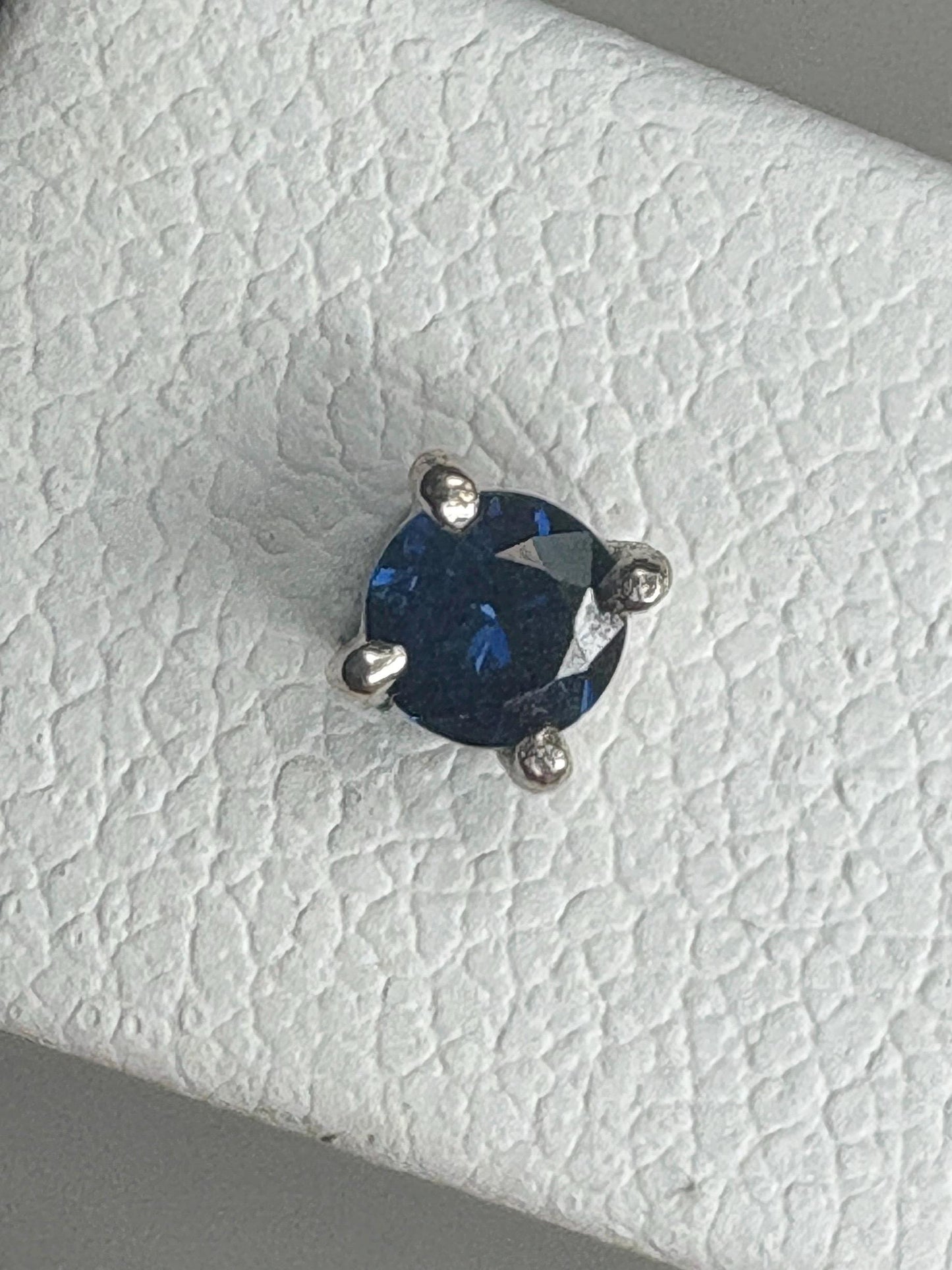 Natural dark blue sapphire stud earrings in solid 14k white gold.