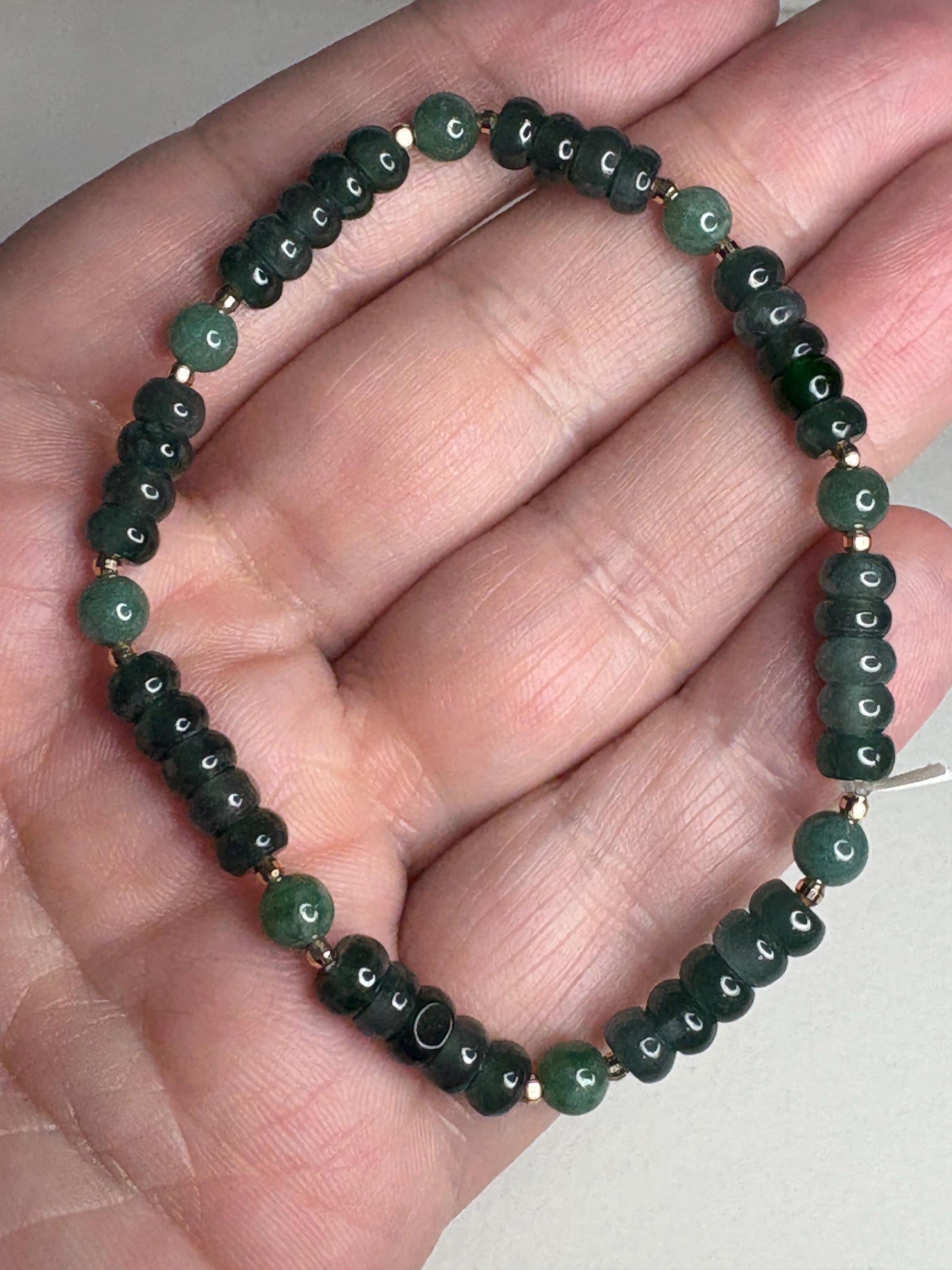 Natural untreated Type A jadeite jade stretch bracelet with solid 14k gold beads.
