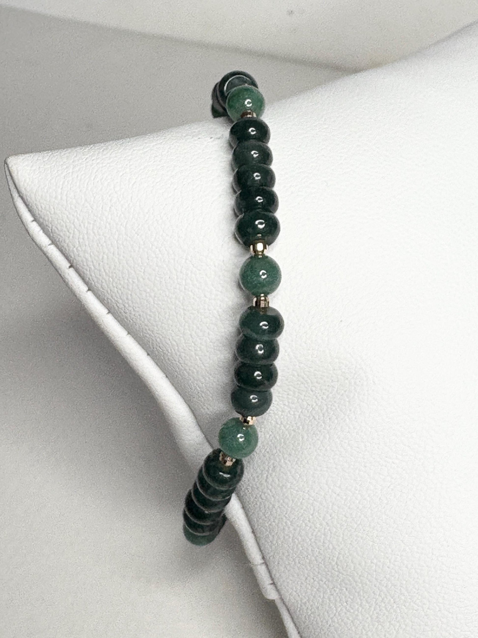 Natural untreated Type A jadeite jade stretch bracelet with solid 14k gold beads.