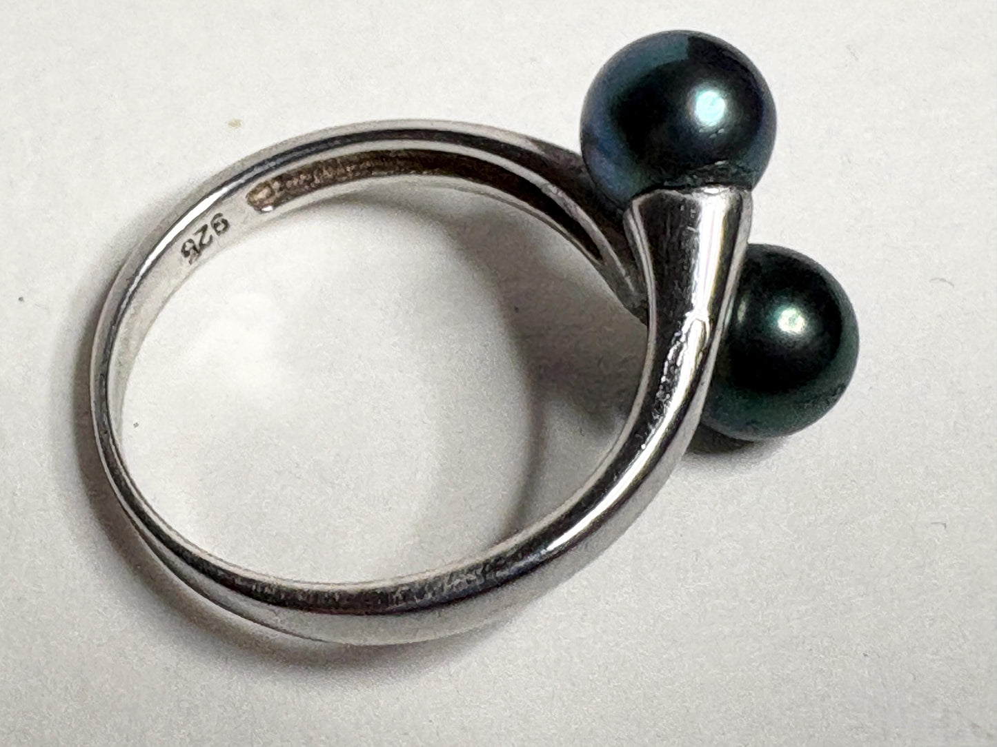 Sterling silver bypass ring with two black cultured Akoya pearls.