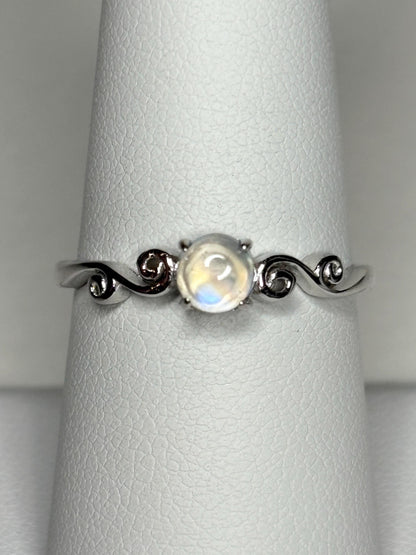 Sterling silver ring with a rainbow moonstone cabochon and swirl details.