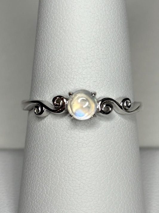 Sterling silver ring with a rainbow moonstone cabochon and swirl details.