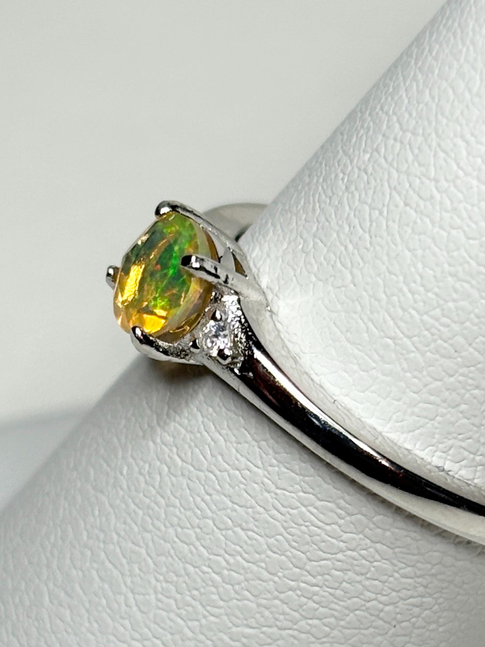 Sterling silver ring with a 5.1mm Ethiopian opal and two small diamonds.