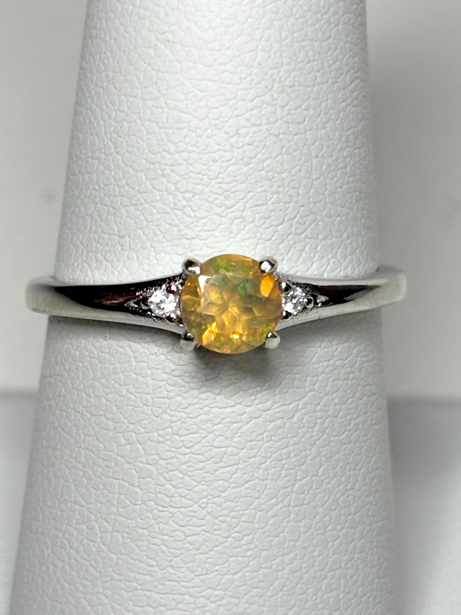 Sterling silver ring with a golden Ethiopian opal and two small diamonds.