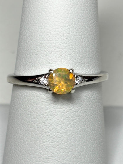 Sterling silver ring with a golden Ethiopian opal and two small diamonds.