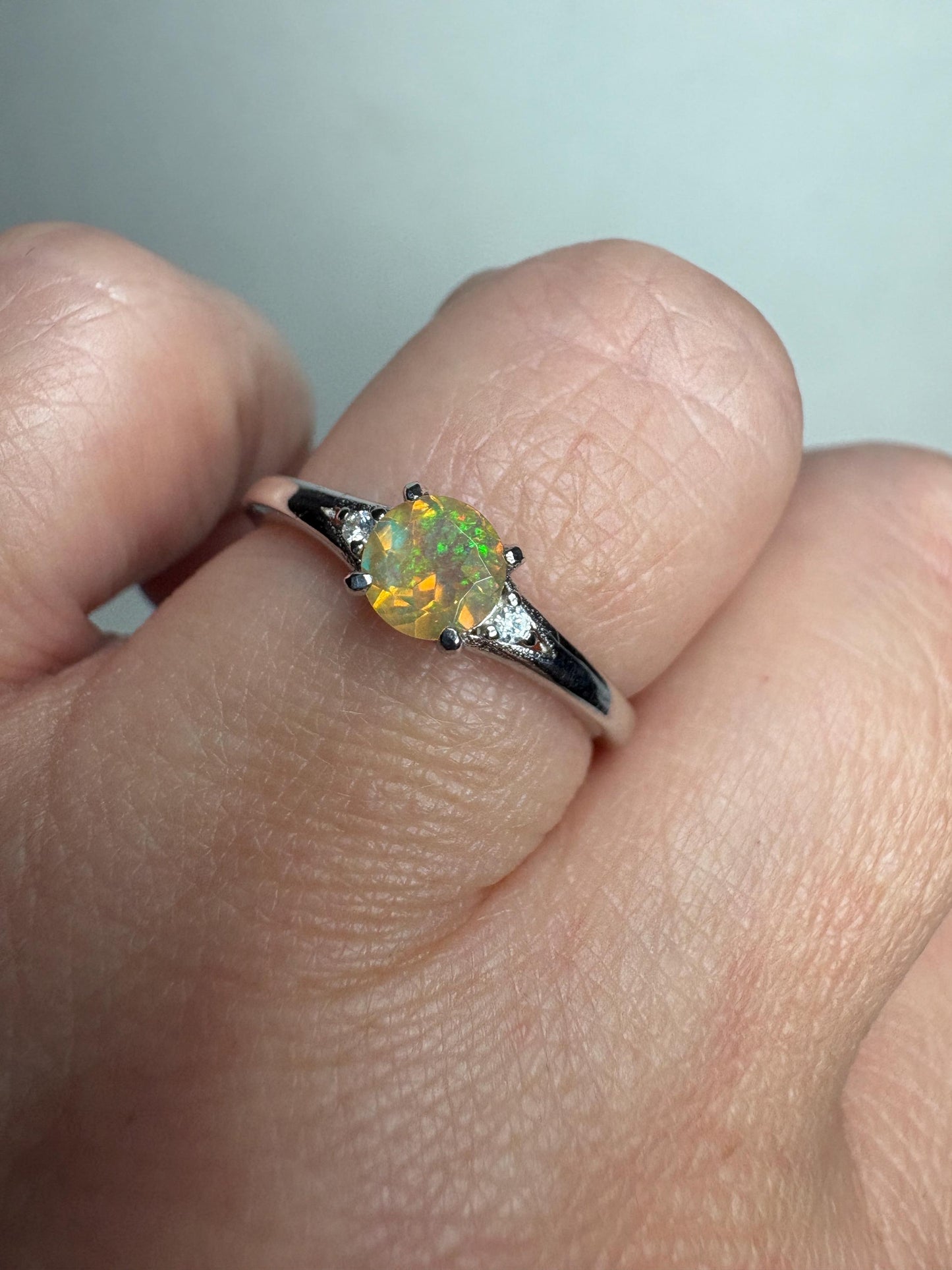 Sterling silver ring with a round Ethiopian opal and small diamonds.