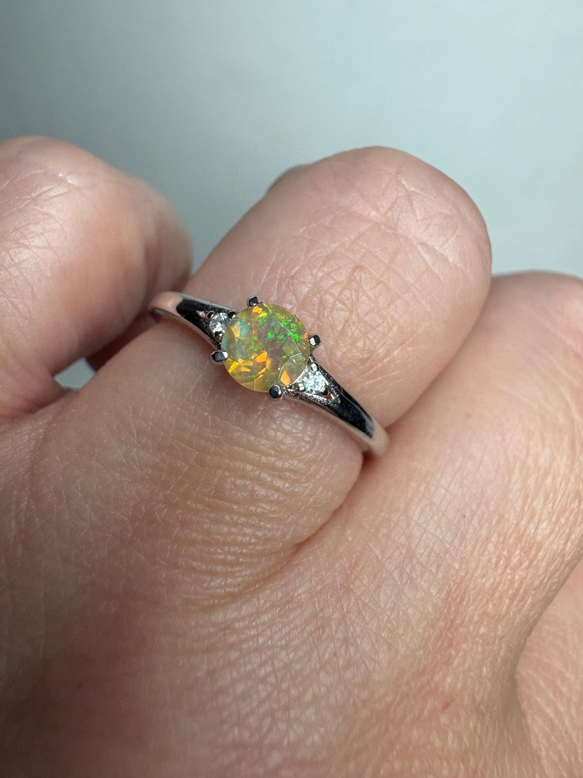 Sterling silver ring with a round Ethiopian opal and small diamonds.