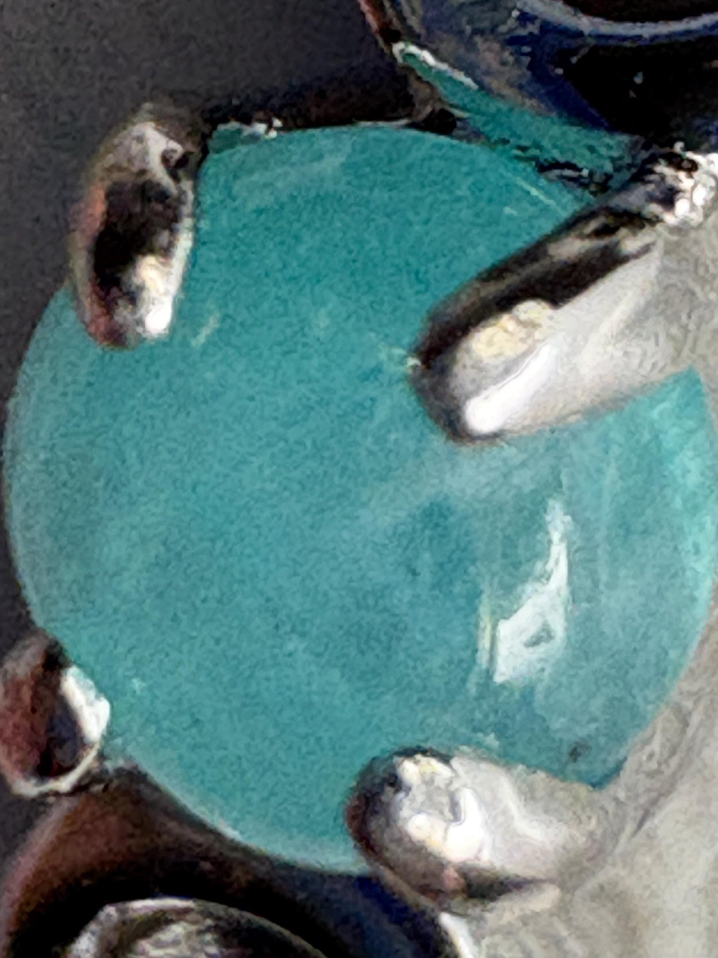 Sterling silver ring with a blue Paraiba tourmaline cabochon.