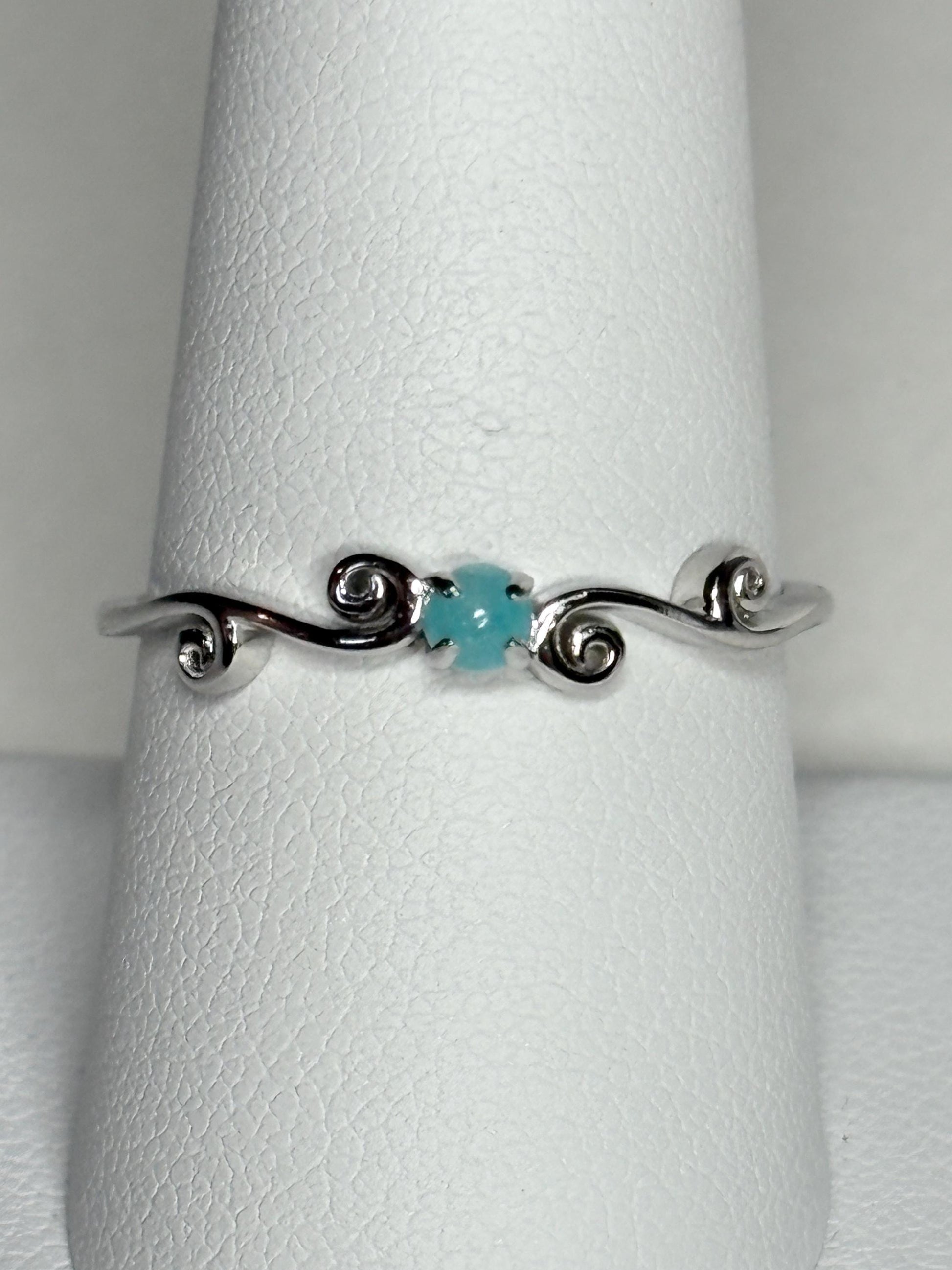Sterling silver ring with a blue tourmaline and swirl design.