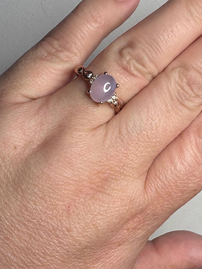 Rose gold ring with oval blue chalcedony and small diamonds.
