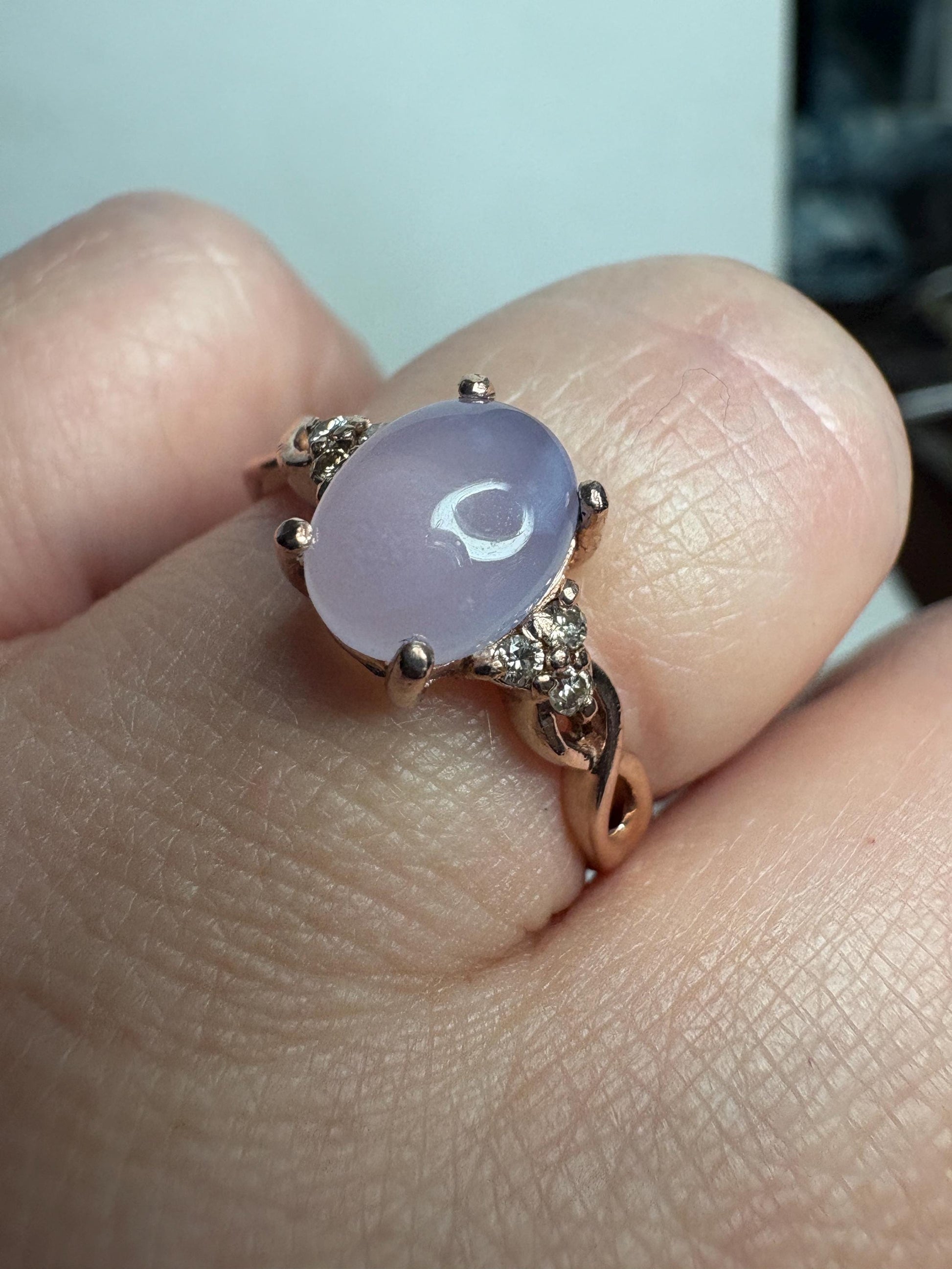 A rose gold ring with a blue chalcedony agate and diamonds.