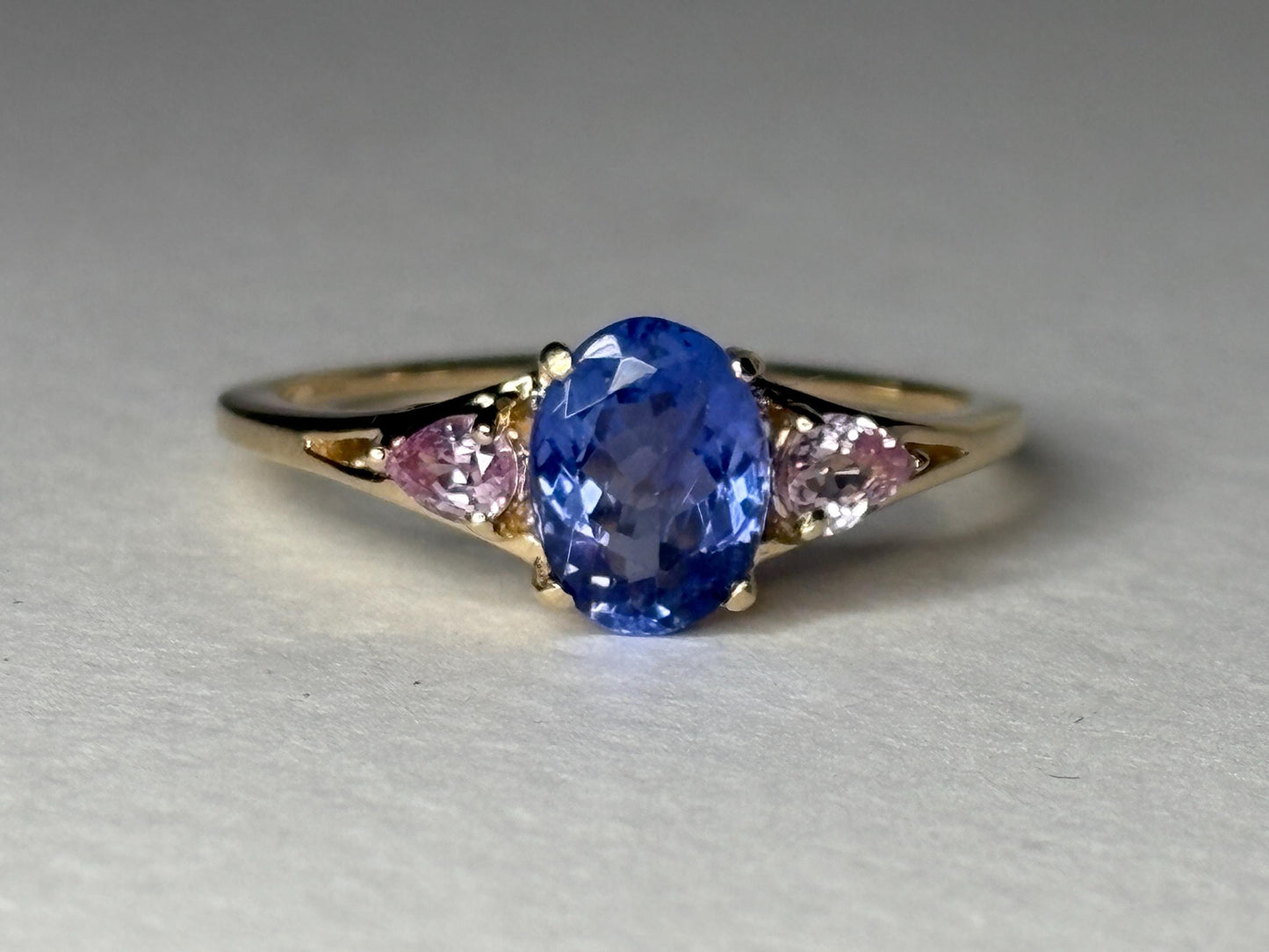Oval tanzanite and pear pink sapphire ring in 9k gold.