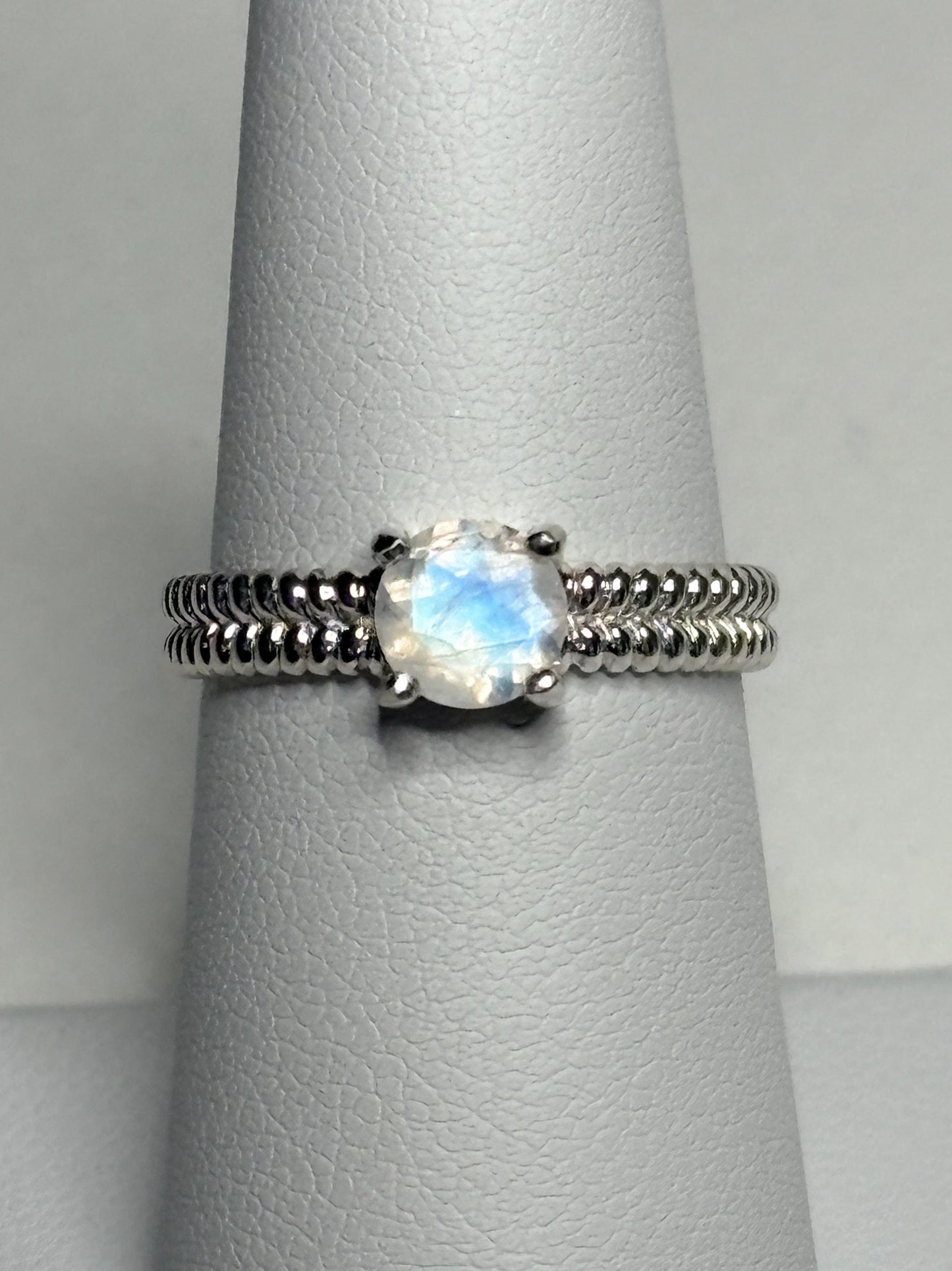 Sterling silver ring with a rainbow moonstone and double rope band.