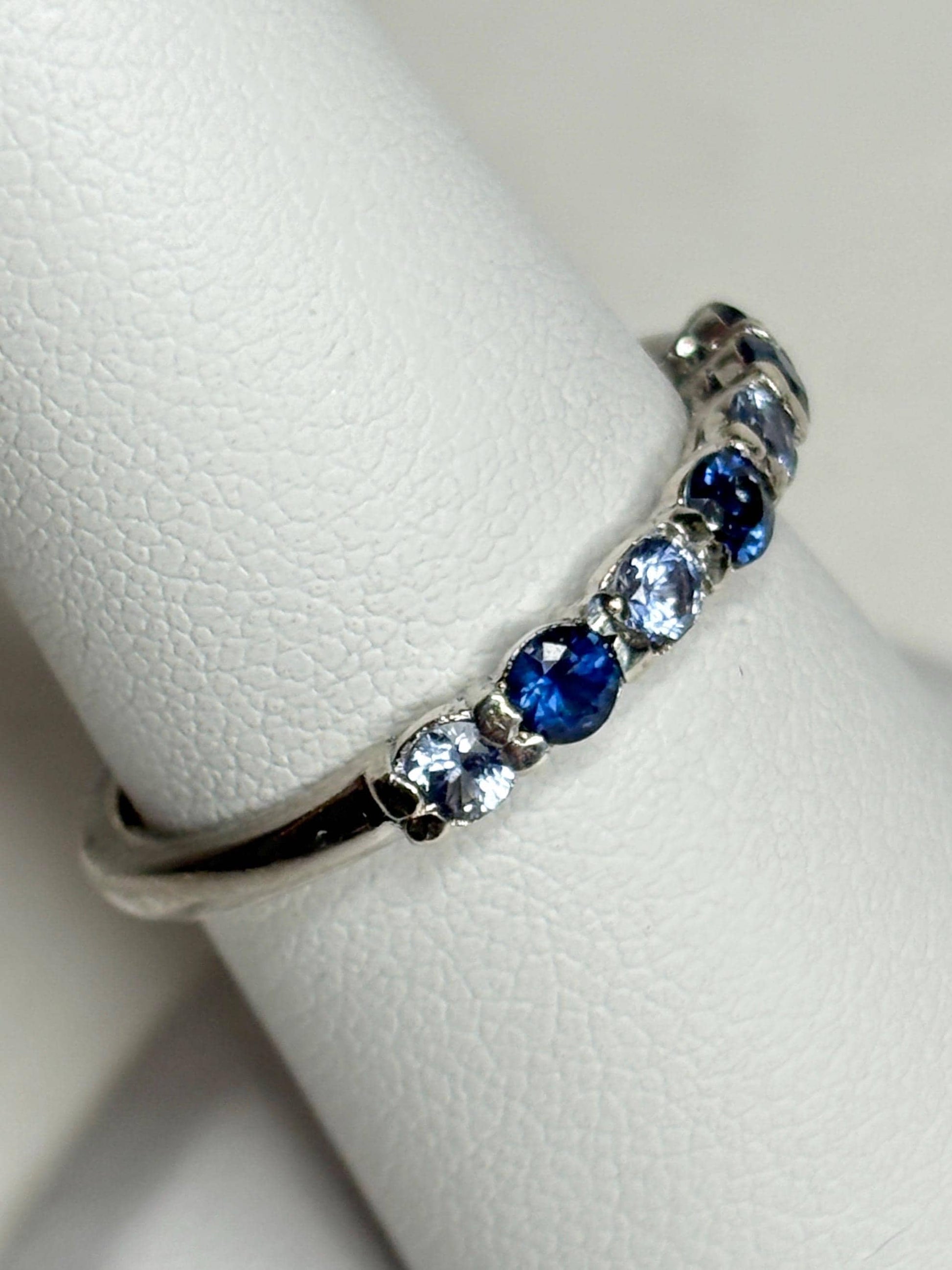 Sterling silver band ring with blue and light blue sapphires.