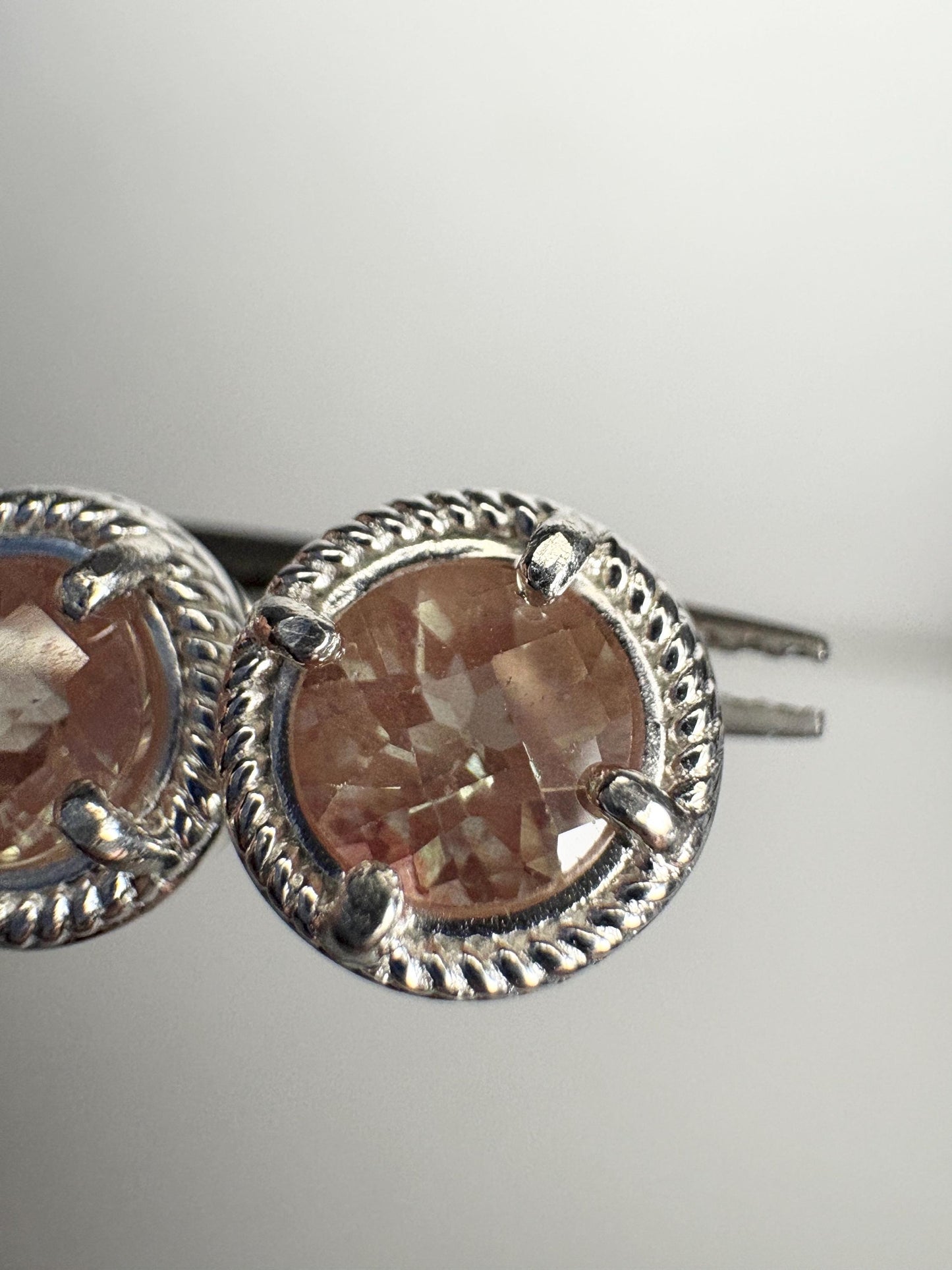 Sterling silver stud earrings with checkerboard faceted andesine gems and rope design.