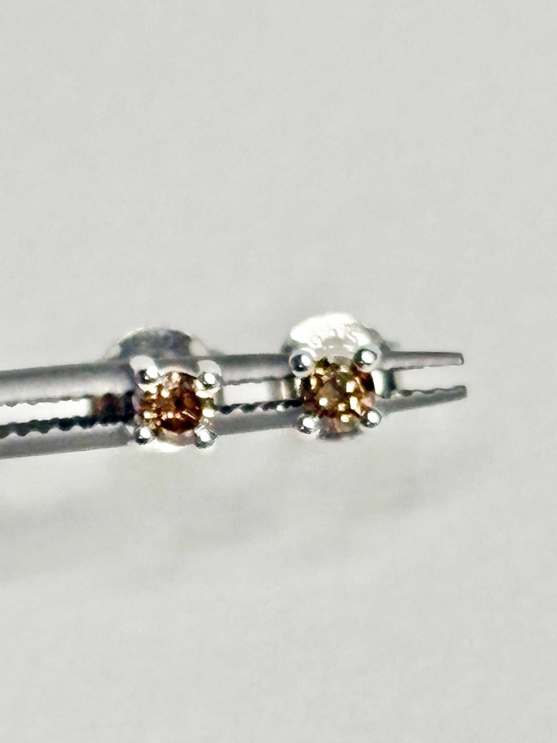 Sterling silver stud earrings with 3mm chocolate champagne colored natural diamonds.