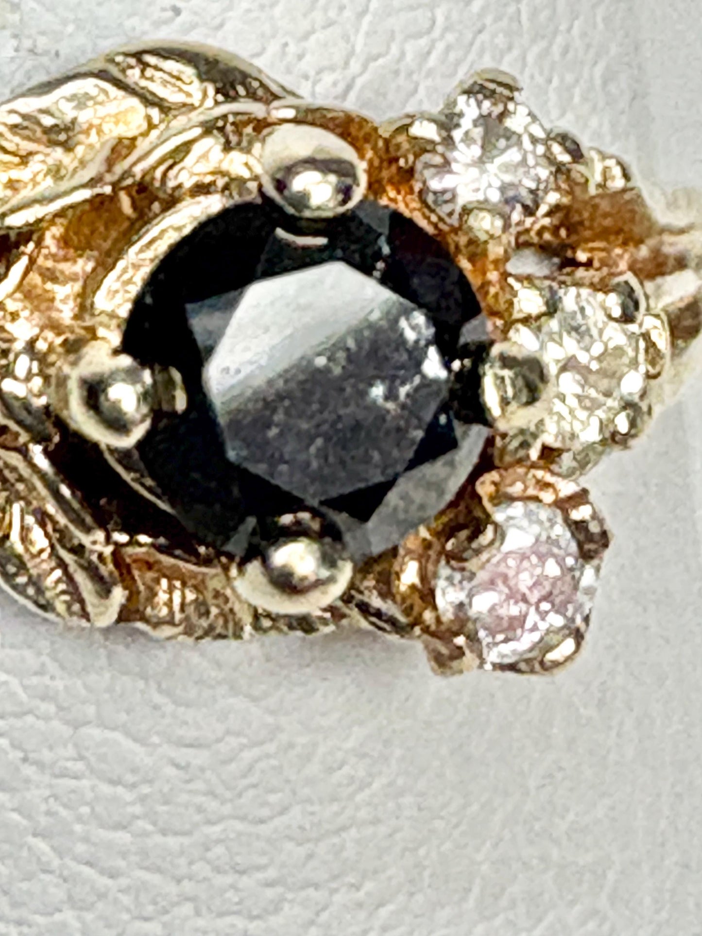 10k yellow gold ring with a black diamond center and accent diamonds.