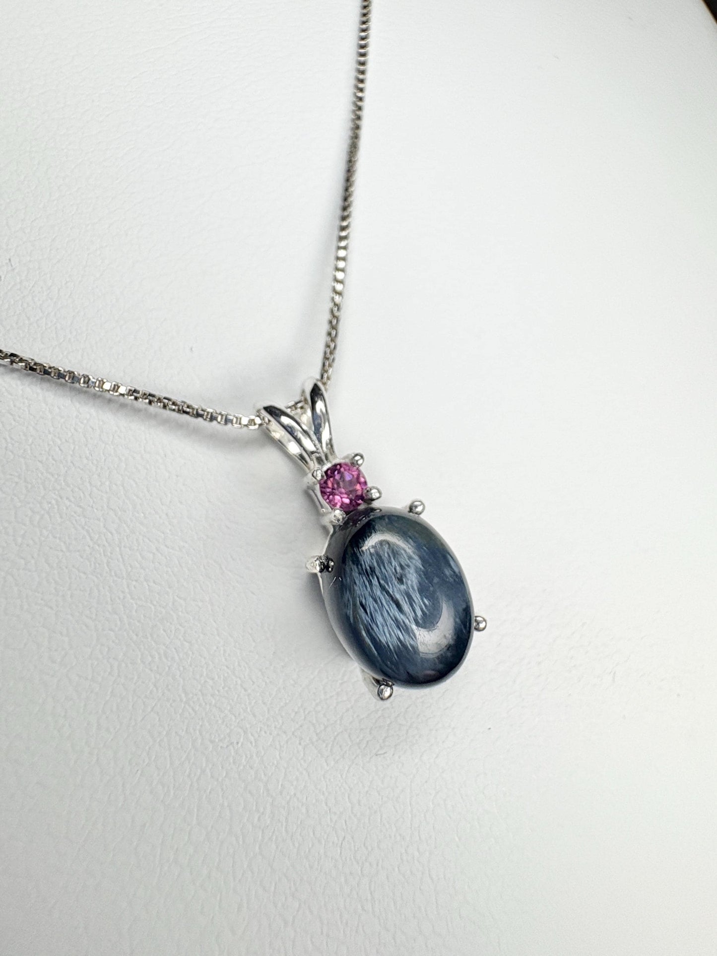 Sterling silver pendant necklace with oval blue pietersite and rhodolite garnet.