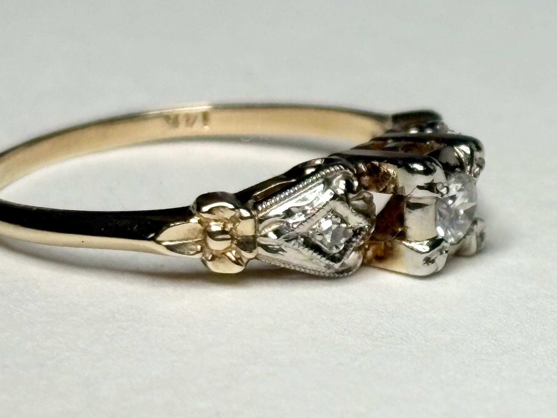 Vintage two-tone 14k gold ring with three diamonds and orange blossom details.