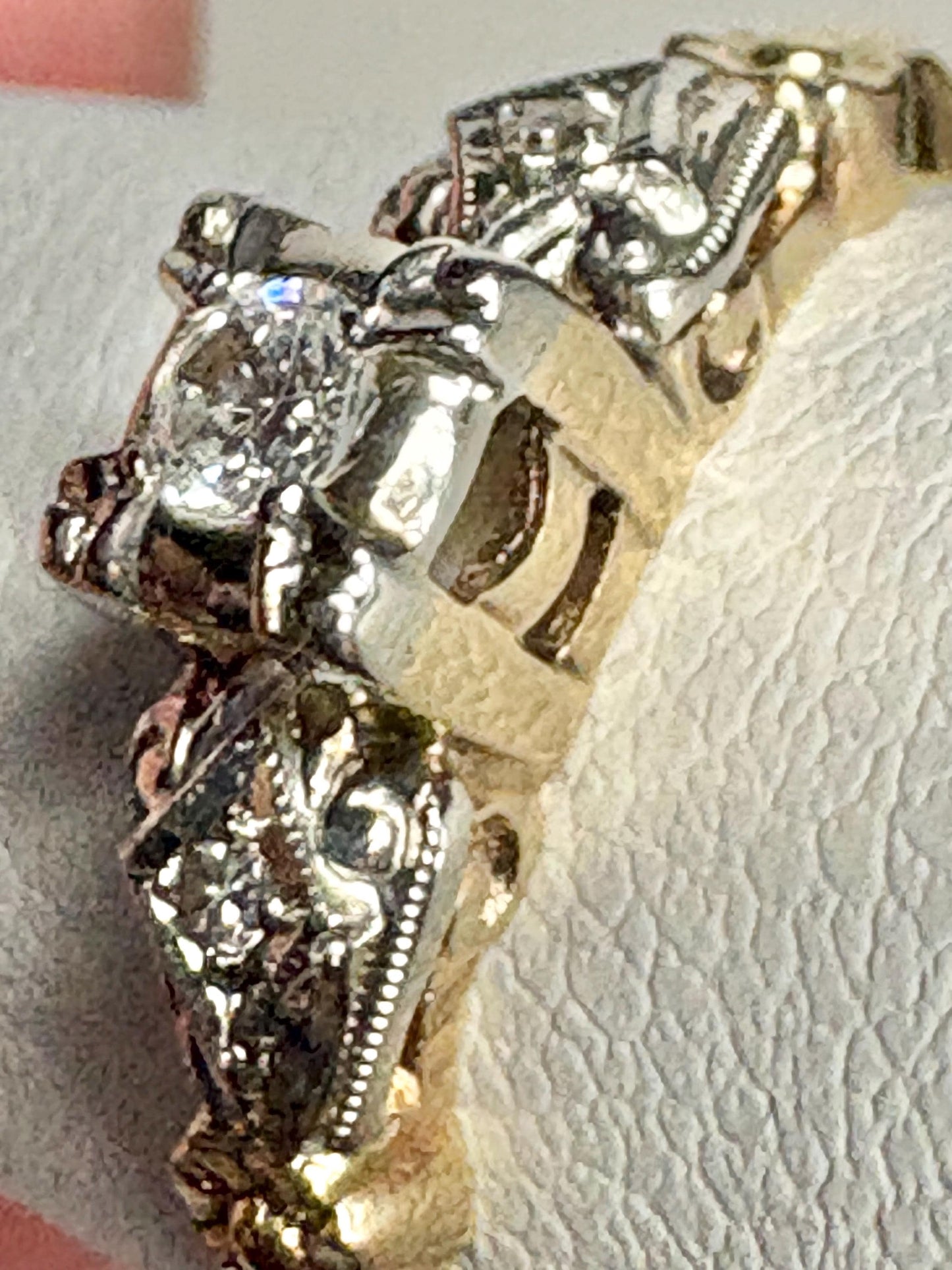 Vintage two-tone 14k gold engagement ring with a central diamond and orange blossom details.